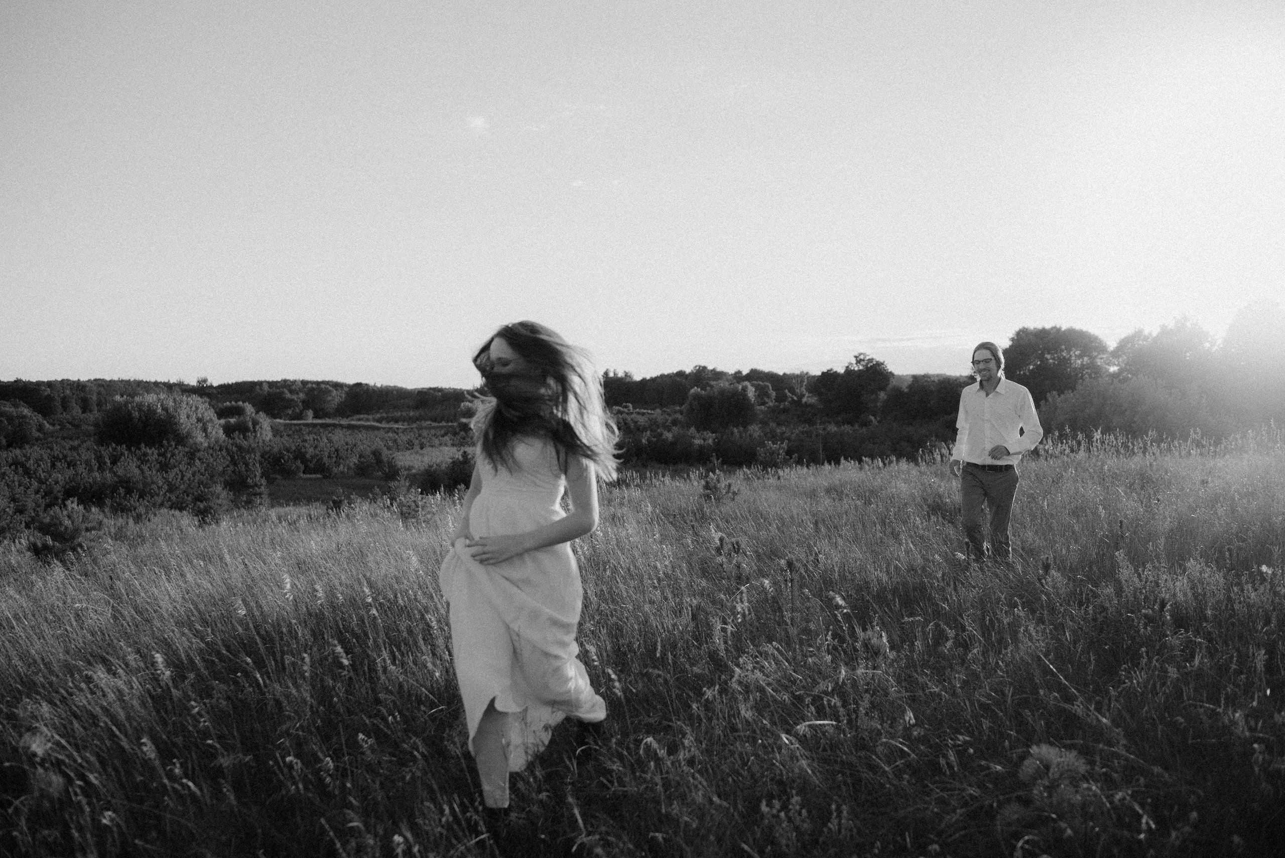 eloping couple running through field